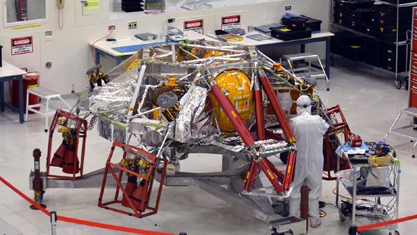 Inside the Spacecraft Assembly Facility at NASA's Jet Propulsion Laboratory near Pasadena, California, an engineer works on the descent stage for the Mars 2020 rover.