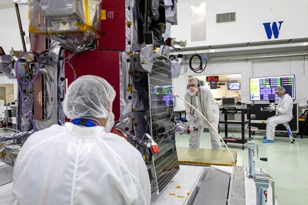 Parker Solar Probe team engineers inspect one of the twin solar arrays installed aboard the spacecraft on May 31, 2018...at Astrotech Space Operations in Titusville, Florida.