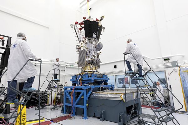 Engineers watch as NASA's Parker Solar Probe spacecraft undergoes vibration testing inside a clean room at the Johns Hopkins University Applied Physics Laboratory.