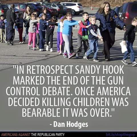 Police officers escort children to safety after the Sandy Hook Elementary School shooting on December 14, 2012.