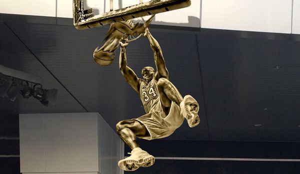 A composite image depicting Shaquille O'Neal's statue outside of STAPLES Center in downtown Los Angeles.