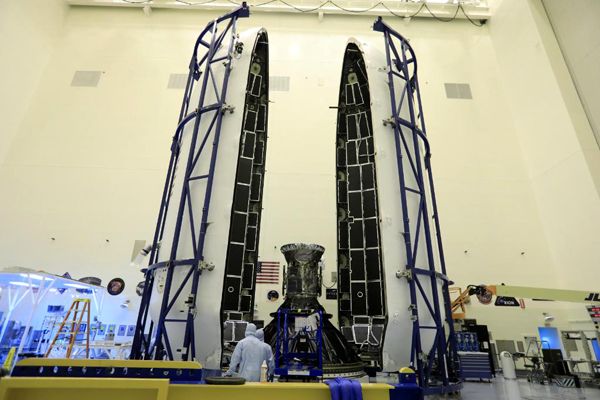 NASA's TESS satellite is about to be encapsulated by the payload fairing for SpaceX's Falcon 9 rocket at Kennedy Space Center in Florida...on April 9, 2018.