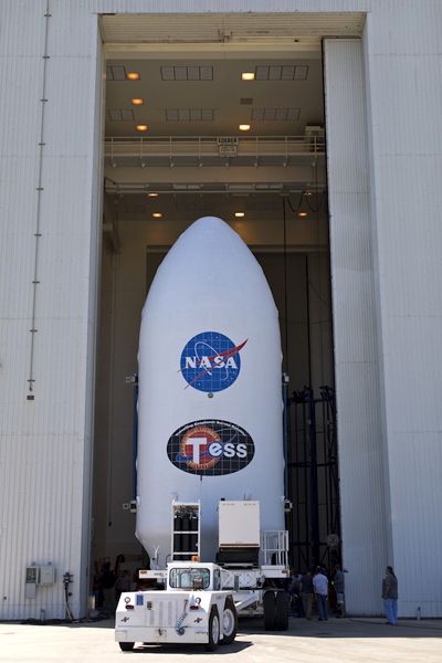 SpaceX's Falcon 9 payload fairing that will enshroud NASA's TESS satellite is moved into the Payload Hazardous Servicing Facility (where TESS awaits the new arrival) at Kennedy Space Center in Florida...on April 3, 2018.
