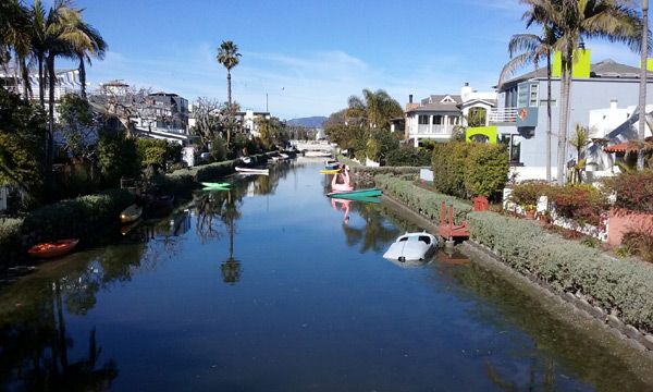 Boats and canoes line the sides of a waterway in the Venice Canal Historic District...on January 30, 2017.