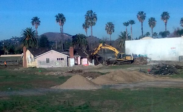 A demolition crew begins tearing down an old abandoned house on a vacant dirt lot behind my home in Pomona, CA...on January 26, 2018.