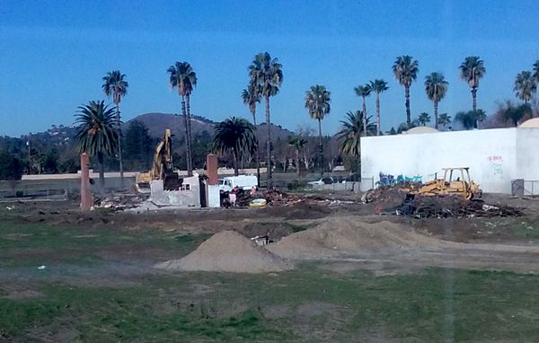 Only the two chimneys of the old abandoned house remain, as a demolition crew continues tearing down the structure on a vacant dirt lot behind my home in Pomona, CA...on January 26, 2018.