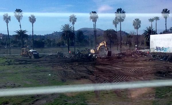 The demolition crew begins cleaning up the area where the old abandoned house once stood on a vacant dirt lot behind my home in Pomona, CA...on January 26, 2018.