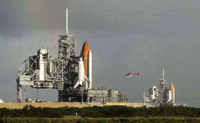 Space shuttle Atlantis stands ready for launch at Kennedy Space Center's Pad 39A in the foreground, while in the background, at Pad 39B 1.6 miles away, Endeavour begins preps for a potential rescue mission to Atlantis if she is found damaged during next month's flight to the Hubble Space Telescope.
