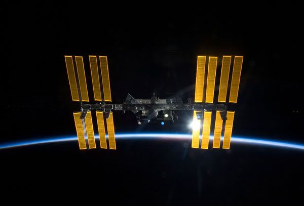 The International Space Station, with orbital sunset behind it.