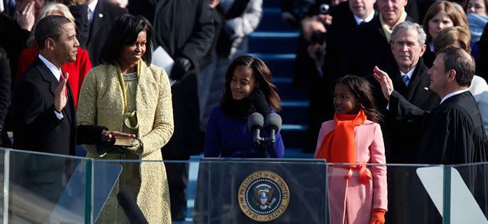 Barack Obama's wife and two daughters, plus George W. Bush in the background, look on as Obama is sworn in as the 44th President of the United States, on January 20, 2009.