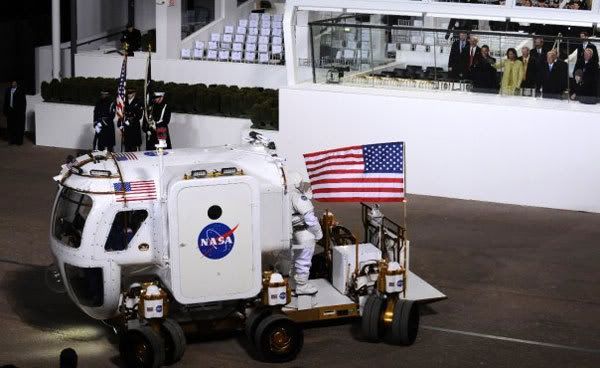 President Obama and his wife Michelle look on from within the reviewing stand as NASA displays its Lunar Electric Rover, during last night's Inaugural Parade in Washington, D.C.