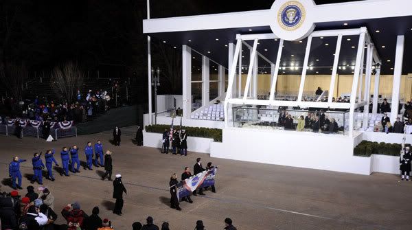 President Obama and his wife Michelle look on from within the reviewing stand as the space shuttle astronauts of flight STS-126 march down Pennsylvania Avenue.