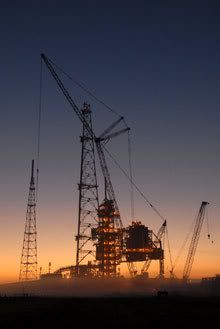 The Sun is about to rise as construction cranes loom around Launch Pad 39-B at Kennedy Space Center, Florida.