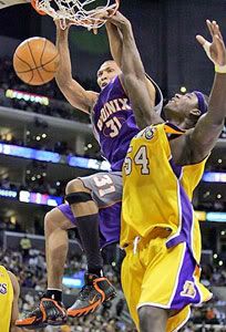 Shawn Marion dunks on Kwame Brown.