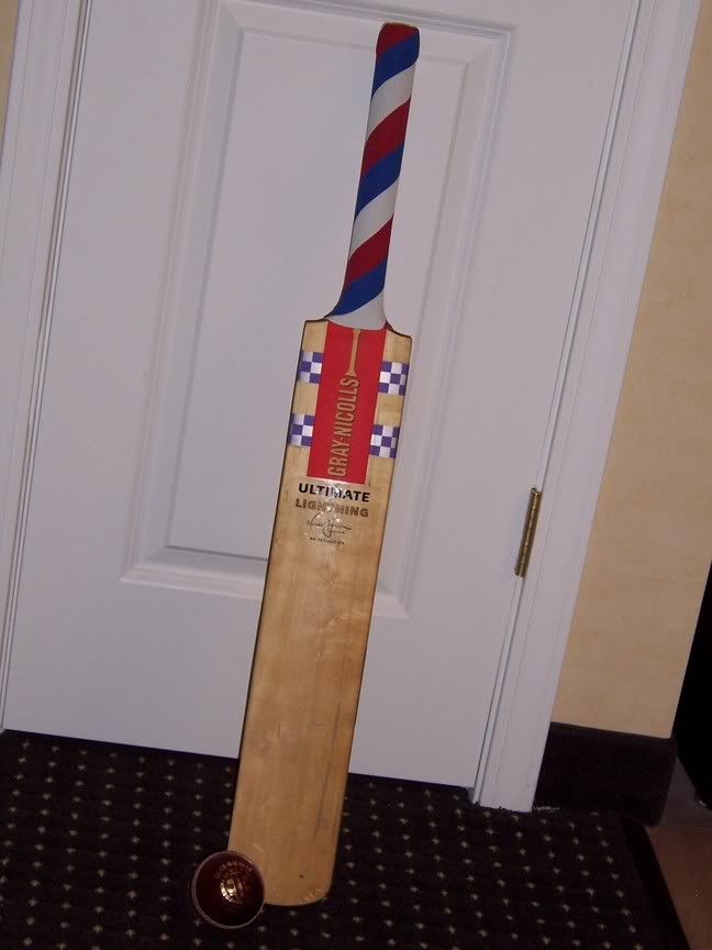 My re-gripped bat and a cricket ball