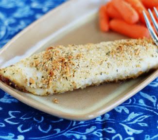 a blue cloth background with a tilapia filet and carrots