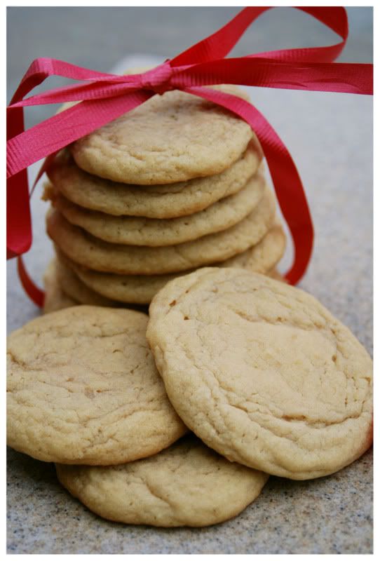 A stack of vanilla butter cookies with a red ribbon