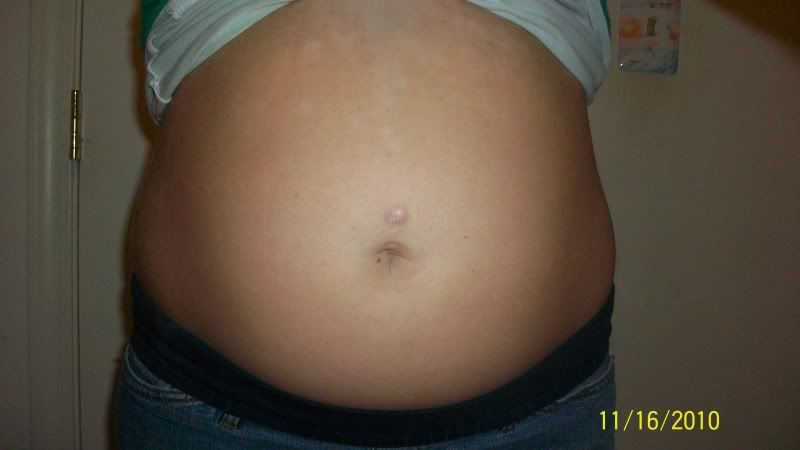 21 weeks & 1 day; i had my belly button pierced [ that what the scar is ]