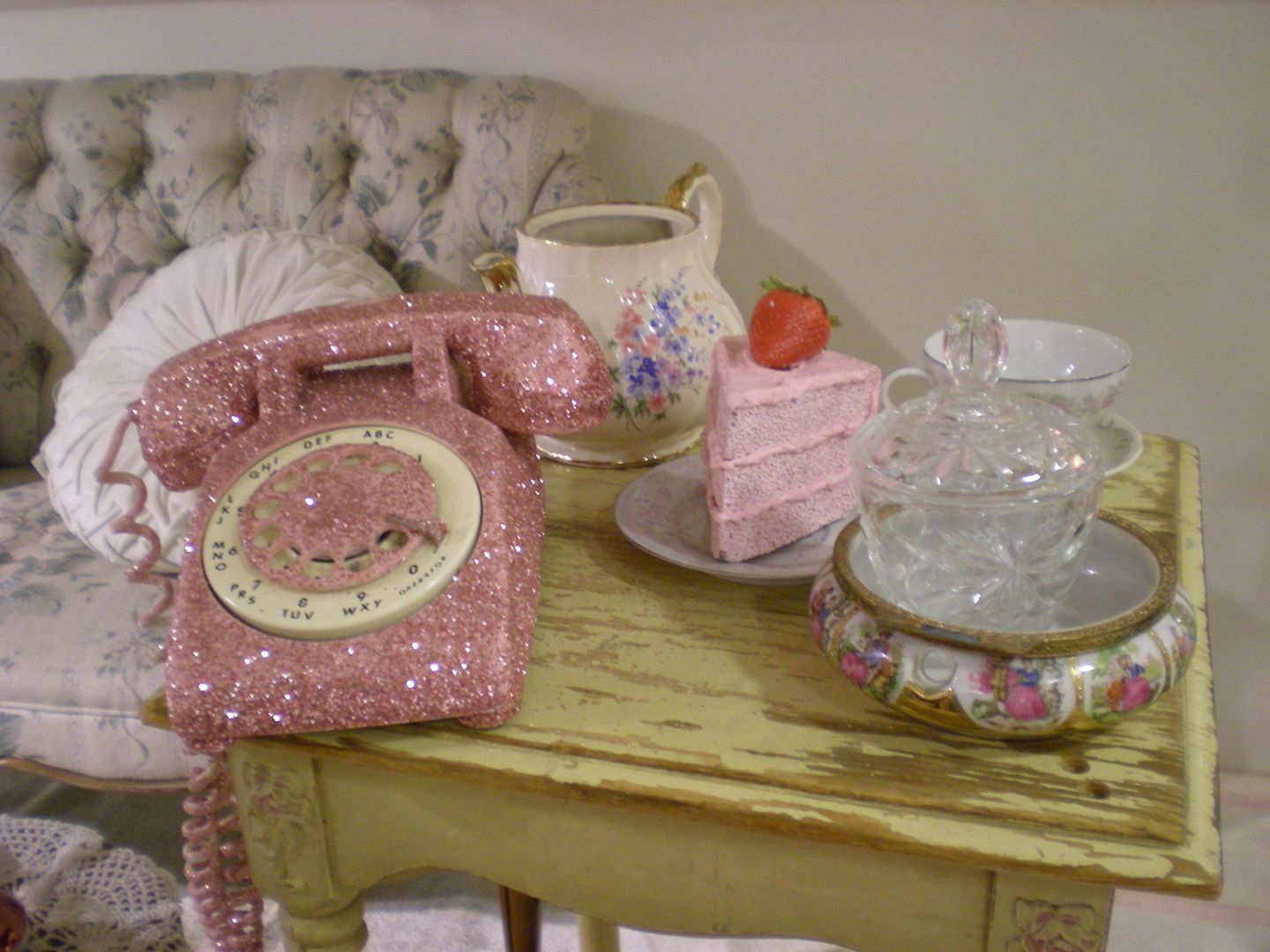 forever 21 store display with hot pink sparkly rotary phone, teacups, and pink cake