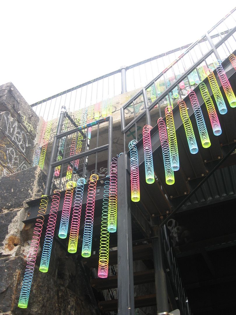 bridge covered in rainbow slinkies