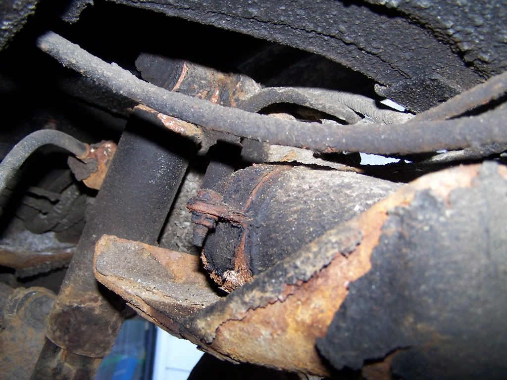 So here's my old and leaky YJ fuel filter. It's located in front of the rear tirer on the inner side of the frame rail (drive side).