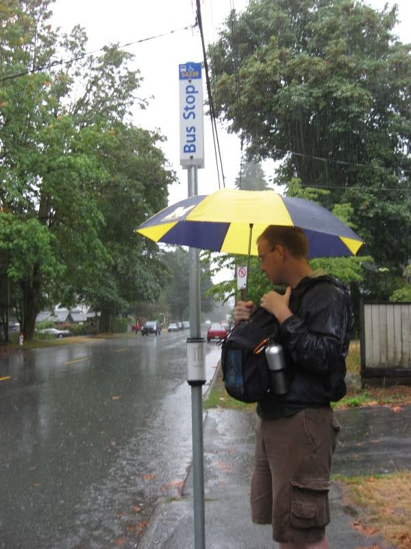 J waiting for the bus in the rain