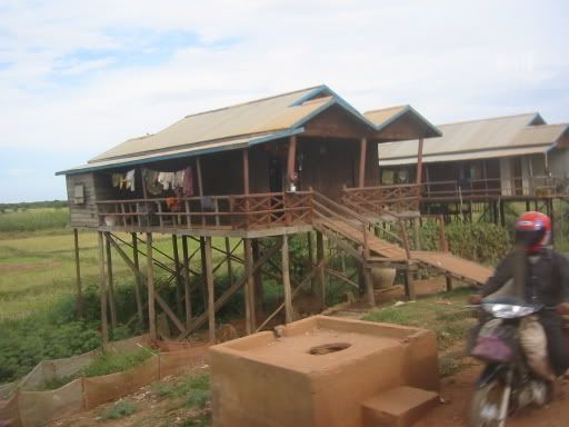 Wooden house beside a dried up river