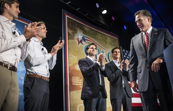image of Mitt Romney onstage with four of his sons, who are applauding him