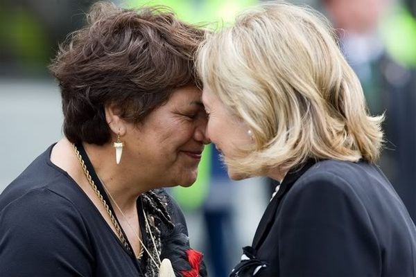 image of Hillary Clinton getting a traditional Maori greeting, forehead-to-forehead, from Rose White–Tahupārae, Kaumatua of New Zealand's Parliament, a fat Maori woman