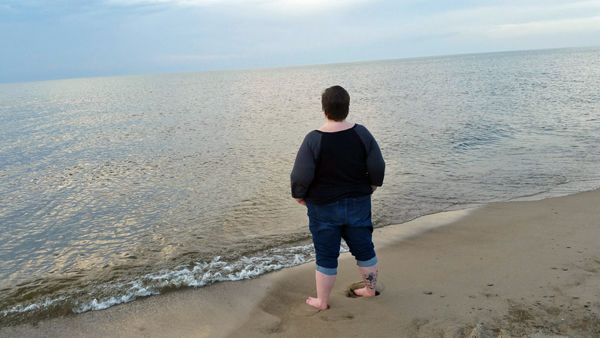 image of me from the back, standing with my hands in my pockets, looking out over the water