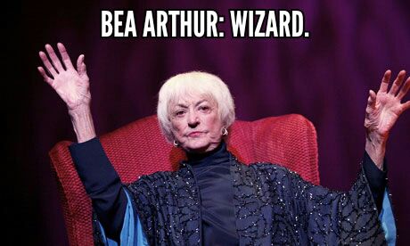 image of Bea Arthur at an event in 2011, wearing a dark, drapey gown and holding her hands in the air, to which I've added text reading: BEA ARTHUR: WIZARD.