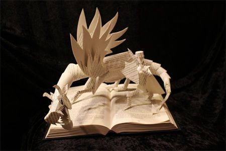 image of a book sculpture in which a knight and a dragon are sculpted from the book's pages