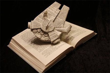 image of a paper sculpture of the Millennium Falcon made from the pages of a book
