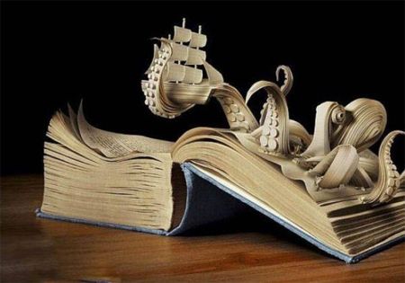 image of a book sculpture of a giant octopus holding a sailing ship in one of its tentacles