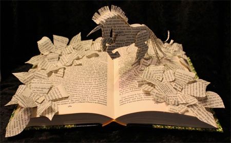 image of a book sculpture in which a unicorn has been sculpted from the book's pages