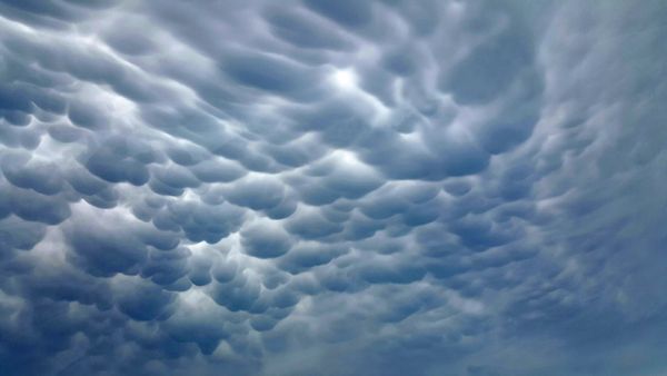 image of puffy, stormy clouds stretching across the sky