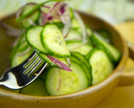 image of sliced cucumber salad in a wooden bowl
