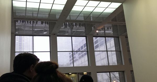 image of the line outside reflected in the ceiling of the interior of the museum