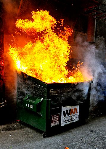 image of a dumpster set ablaze