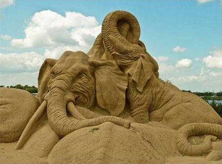 image of a sculpture of elephants done in sand