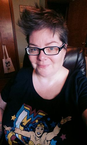 image of me sitting at my desk, wearing a Wonder Woman t-shirt