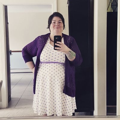 image of me standing in front of a mirror wearing a white dress with purple polka dots and a purple cardigan