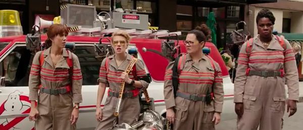 screen cap of the four Ghostbusters, with Leslie Jones on the far right, towering over the other three