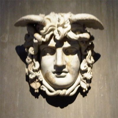 image of a stone gorgon; the face of a woman with horns and hair of snakes