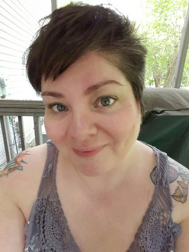 image of me on my deck wearing green eye shadow and pink blush