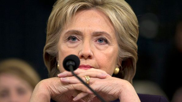 image of Hillary Clinton at today's Benghazi hearing, with her fingers intertwined, glowering at her hands at whichever dipshit Republican is speaking