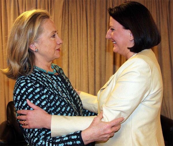 image of Hillary Clinton with President of the Republic of Kosovo, Madam Atifete Jahjaga, a thin white woman; they are greeting each other warmly face-to-face