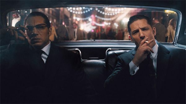 image of Tom Hardy as Ronnie Kray and Tom Hardy as Reggie Kray, sitting in the backseat of a car in the film 'Legend'