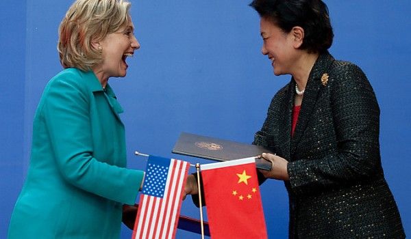 image of Hillary Clinton with Vice Premier of the People's Republic of China Liu Yandong, a thin Chinese woman; they are greeting each other with smiles