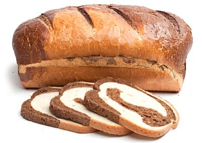 image of a loaf and several slices of marble rye bread